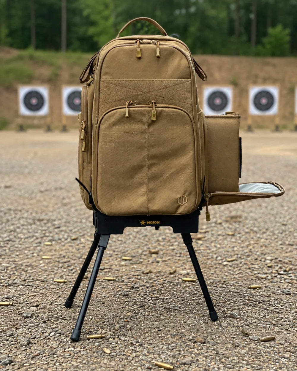 A loaded range bag standing upright on the Ryzer Go beside an outdoor firing line
